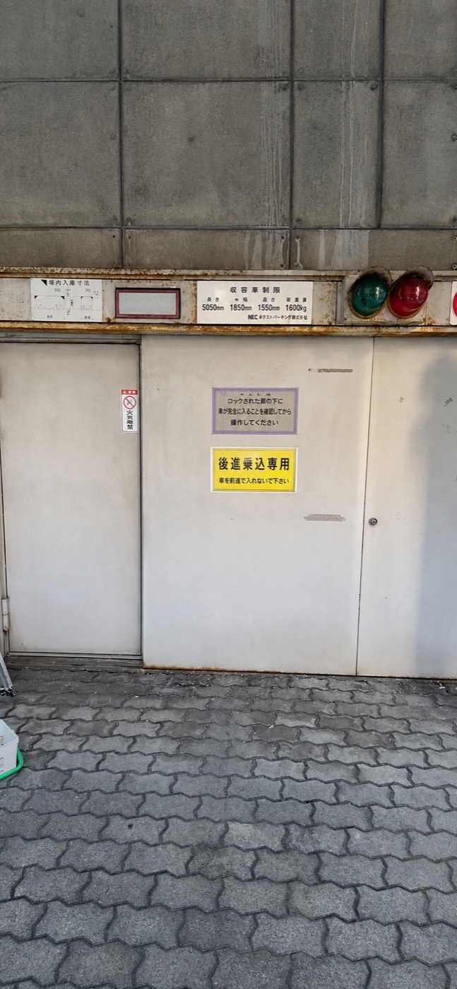 立体駐車場の大型扉を正面から見た塗装施工の様子